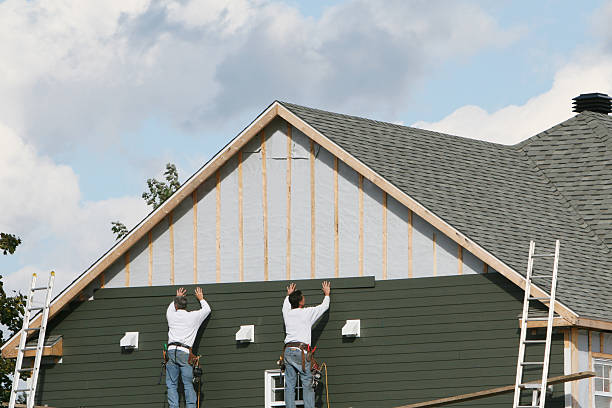 Professional Storm Damage Siding Repair technician working in Colchester, IL